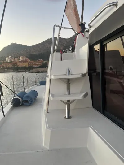  Yacht Photos Pics 2019 Bali 4.3 yacht deck with steps, docked near scenic coastline.