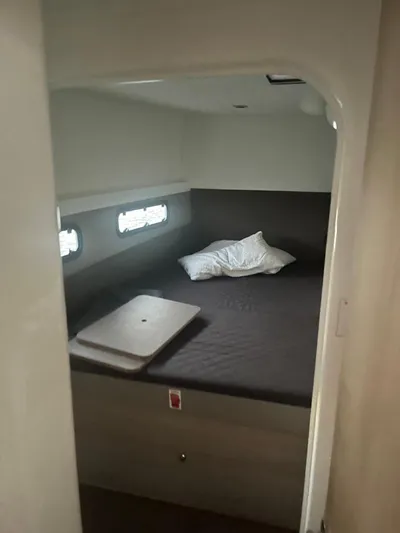  Yacht Photos Pics Interior cabin of a 2019 Bali 4.3 yacht with bed and porthole windows.