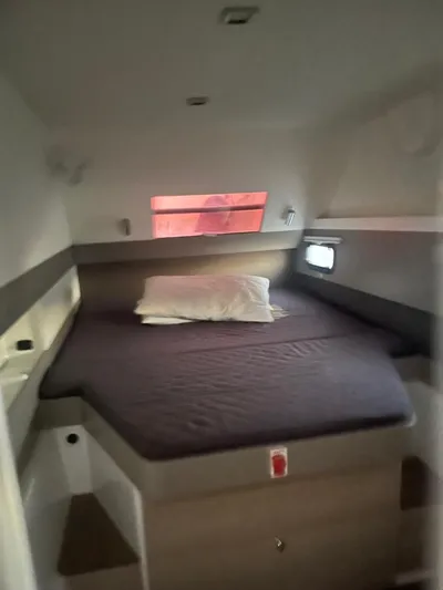  Yacht Photos Pics Cozy cabin interior of 2019 Bali 4.3 yacht with bed and porthole windows.