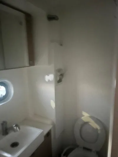 Yacht Photos Pics Compact bathroom in a 2019 Bali 4.3 yacht with sink, mirror, and toilet.