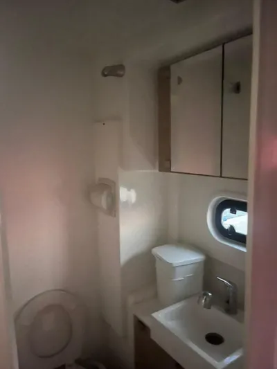  Yacht Photos Pics Compact bathroom in a 2019 Bali 4.3 yacht with sink, toilet, and storage cabinets.