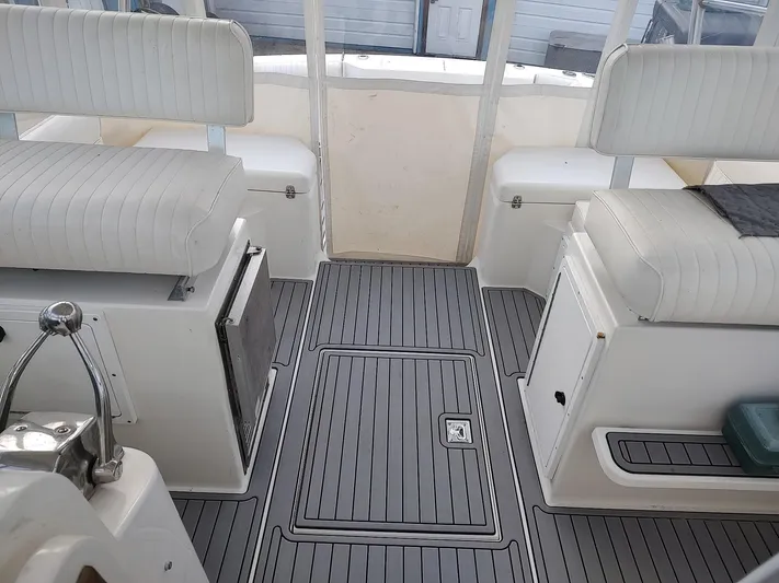  Yacht Photos Pics 1998 Cabo 31 Express boat interior with white seating and gray flooring.