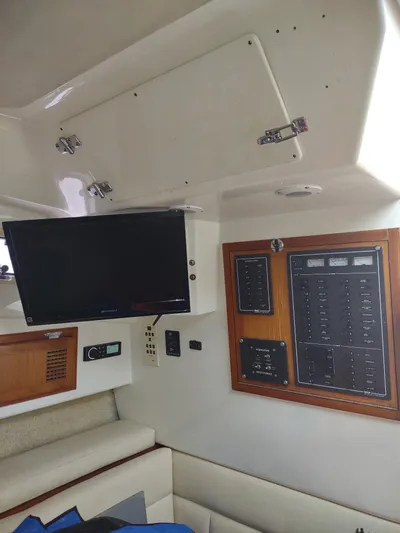  Yacht Photos Pics Interior of 1998 Cabo 31 Express boat with control panel and mounted TV.