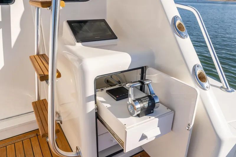 Chaser Yacht Photos Pics Control panel of 2014 Viking 46 Convertible yacht with wooden steps and water view.