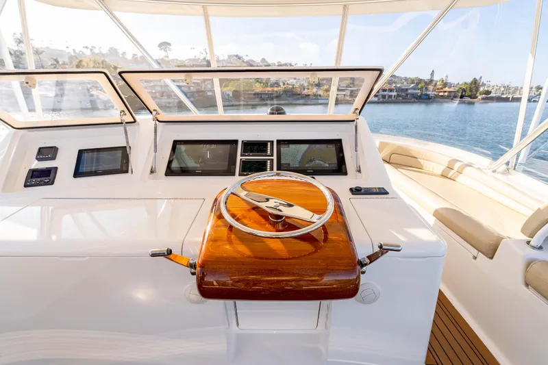 Chaser Yacht Photos Pics 2014 Viking 46 Convertible yacht helm with wooden steering wheel and navigation screens.