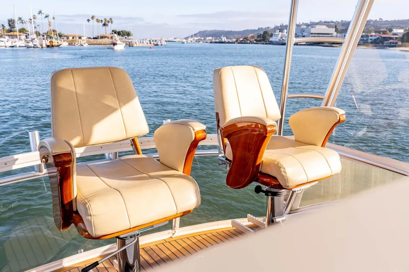 Chaser Yacht Photos Pics Luxurious seating on 2014 Viking 46 Convertible yacht, overlooking scenic marina view.