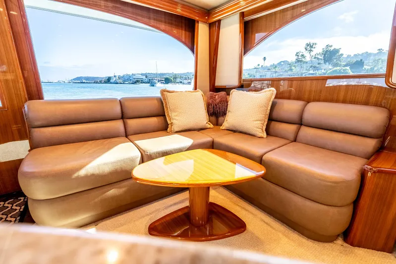 Chaser Yacht Photos Pics Luxurious interior of 2014 Viking 46 Convertible yacht with plush seating and scenic window view.