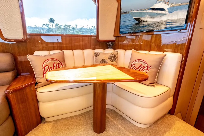 Chaser Yacht Photos Pics Cozy seating area in 2014 Viking 46 Convertible yacht with decorative pillows and wooden table.