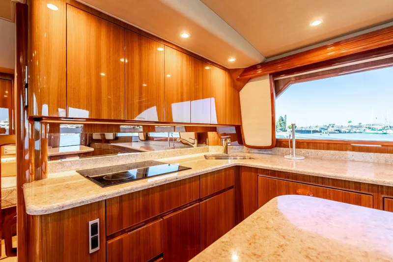Chaser Yacht Photos Pics Luxurious kitchen interior of 2014 Viking 46 Convertible yacht with wood cabinetry and ocean view.