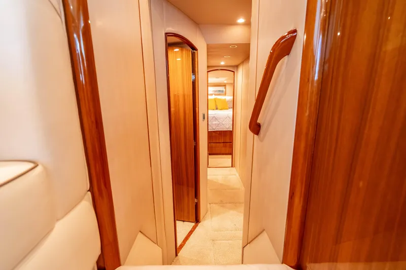 Chaser Yacht Photos Pics Luxurious interior hallway of 2014 Viking 46 Convertible yacht with wood accents.