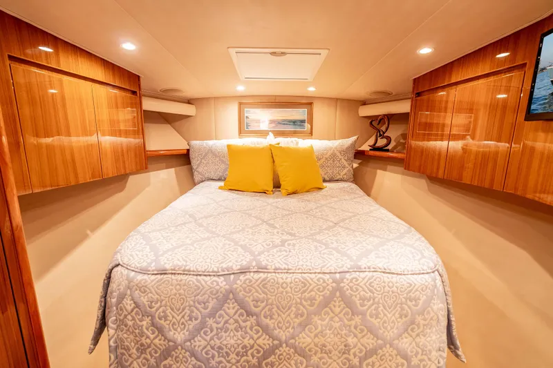 Chaser Yacht Photos Pics Luxurious cabin interior of 2014 Viking 46 Convertible yacht with elegant bedding and wood finishes.