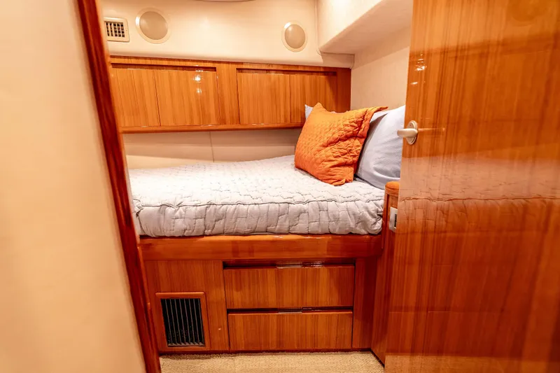 Chaser Yacht Photos Pics Luxurious cabin interior of 2014 Viking 46 Convertible yacht with cozy bedding and wooden finishes.