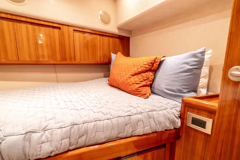 Chaser Yacht Photos Pics Cozy cabin interior of 2014 Viking 46 Convertible yacht with wooden accents and plush bedding.