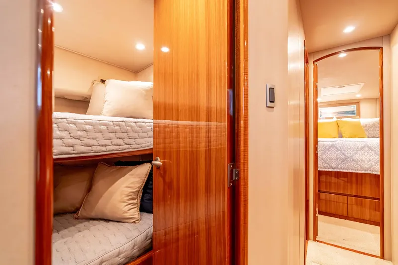 Chaser Yacht Photos Pics Interior of 2014 Viking 46 Convertible yacht with cozy bunk beds and elegant wood finish.