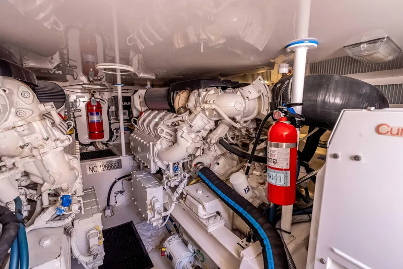 Chaser Yacht Photos Pics Engine room of 2014 Viking 46 Convertible yacht, featuring dual engines and fire extinguishers.