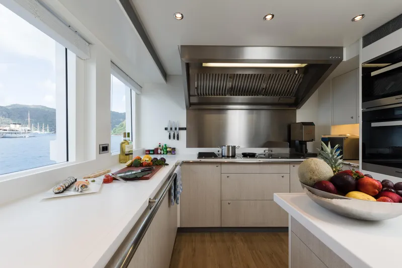 Laurentia Yacht Photos Pics Modern yacht kitchen with fruit bowl, sushi, and ocean view; Heesen Fast Displacement Motor Yacht 2017.