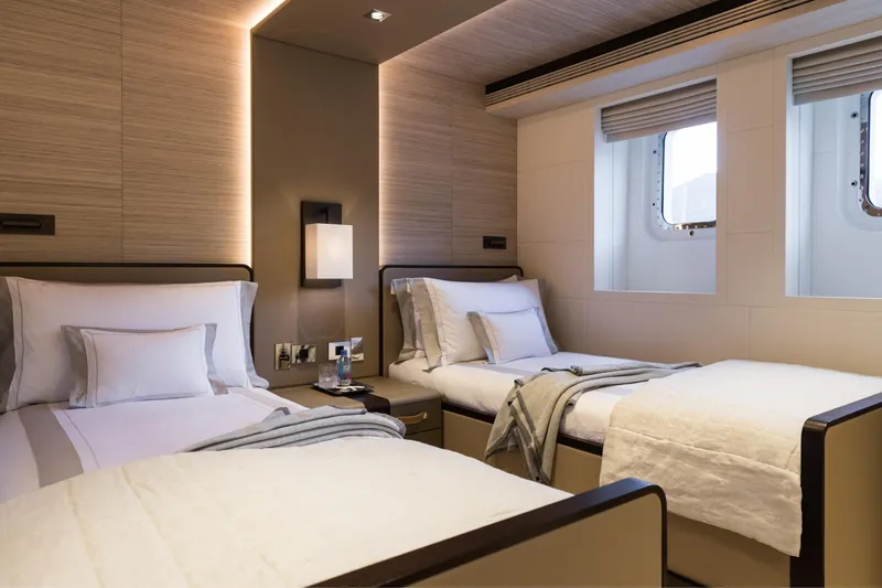 Laurentia Yacht Photos Pics Luxurious twin bedroom on 2017 Heesen Fast Displacement Motor Yacht, featuring elegant decor and natural light.