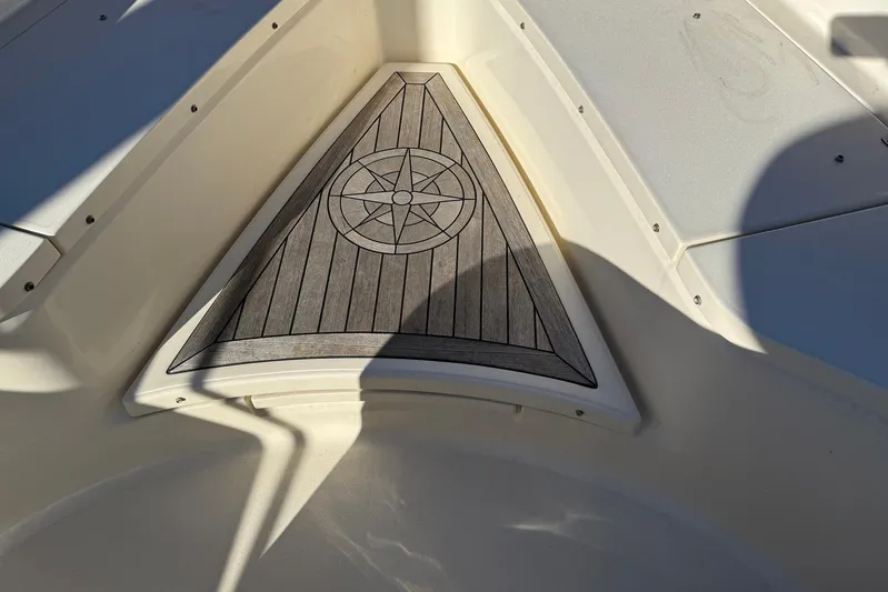 Electric Arc Yacht Photos Pics 2018 Scout 350 LXF boat deck with compass design, sunlight casting shadows.