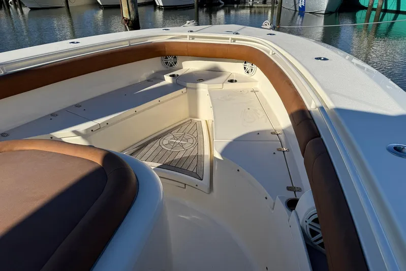 Electric Arc Yacht Photos Pics 2018 Scout 350 LXF boat interior with cushioned seating and wood accents.