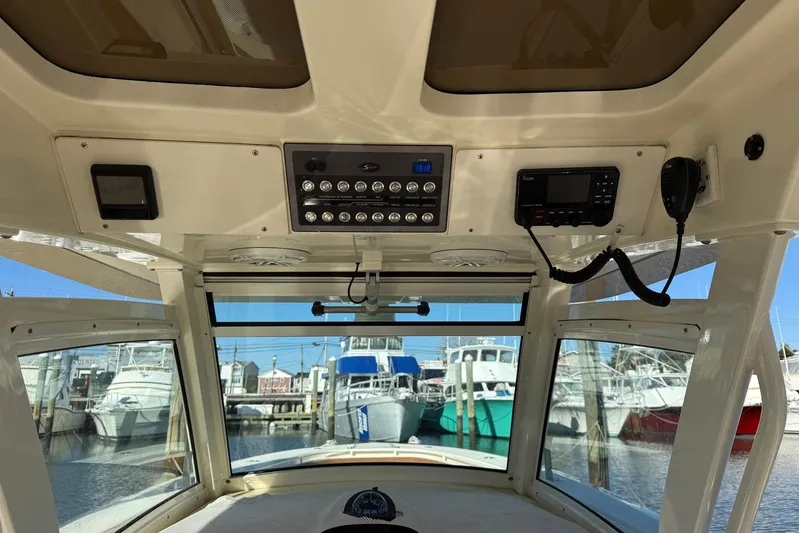 Electric Arc Yacht Photos Pics Interior view of 2018 Scout 350 LXF boat with control panel and marina background.
