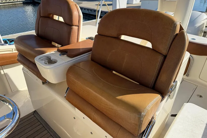 Electric Arc Yacht Photos Pics Luxurious seating on a 2018 Scout 350 LXF boat, featuring brown leather upholstery.