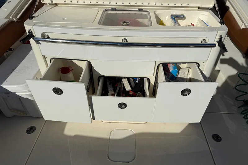 Electric Arc Yacht Photos Pics 2018 Scout 350 LXF boat storage compartments with open drawers and visible contents.