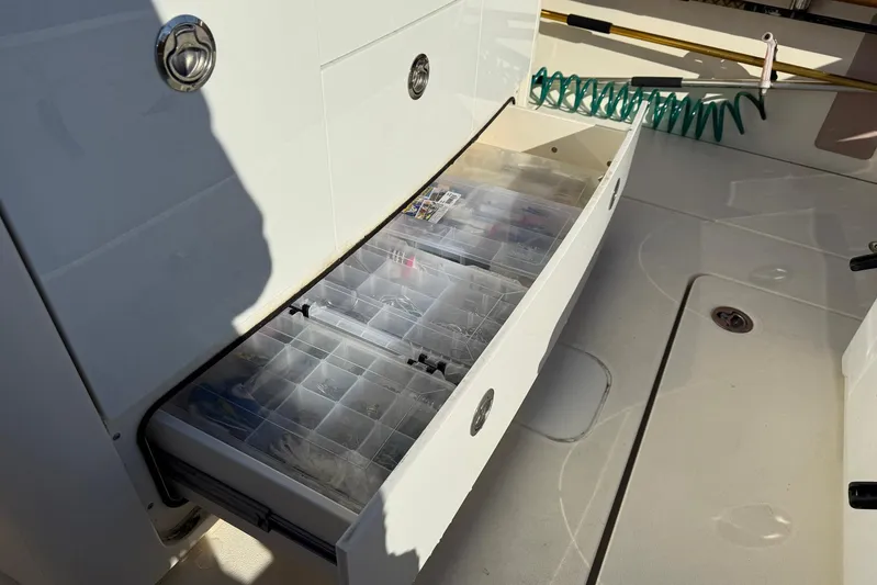 Electric Arc Yacht Photos Pics 2018 Scout 350 LXF boat with open storage drawer containing organized fishing gear.