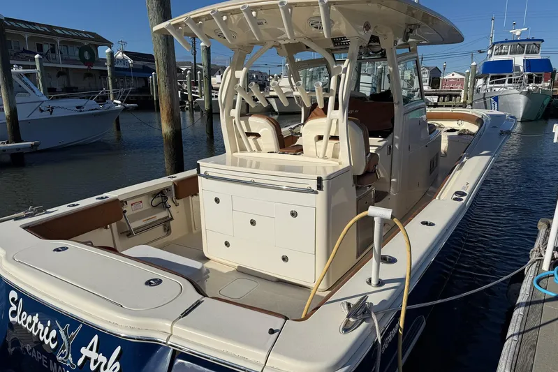 Electric Arc Yacht Photos Pics 2018 Scout 350 LXF boat docked at marina, showcasing spacious deck and seating.