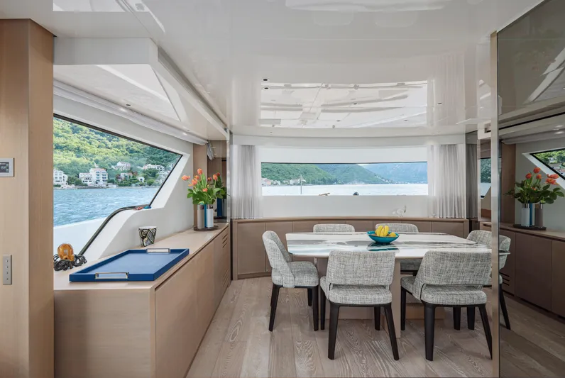 Zafiro III Yacht Photos Pics Luxurious interior of 2020 Sanlorenzo SX88 yacht with elegant dining area and scenic views.