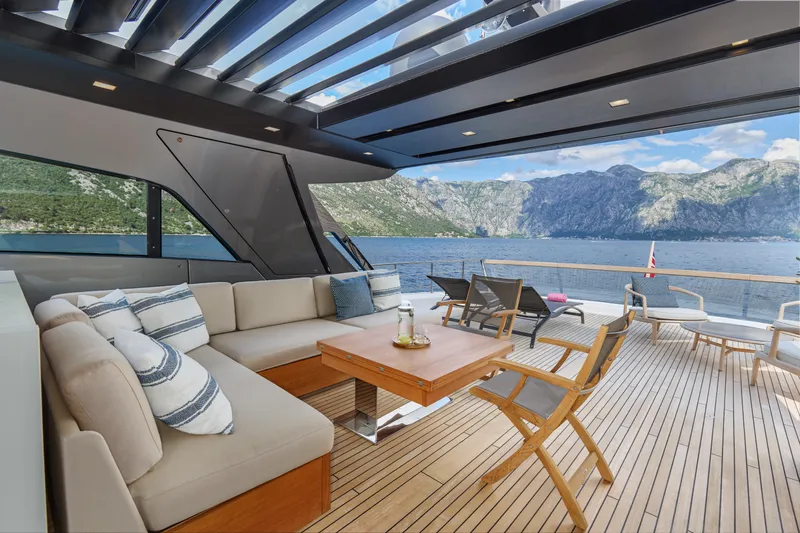 Zafiro III Yacht Photos Pics Luxurious Sanlorenzo SX88 yacht deck with seating, table, and scenic ocean view, 2020 model.