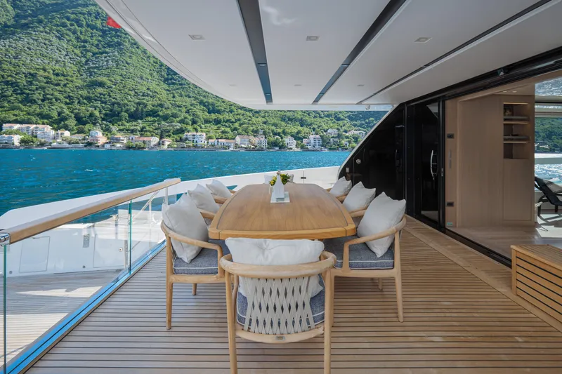 Zafiro III Yacht Photos Pics Luxury Sanlorenzo SX88 yacht deck with dining area, overlooking scenic waterfront, 2020 model.