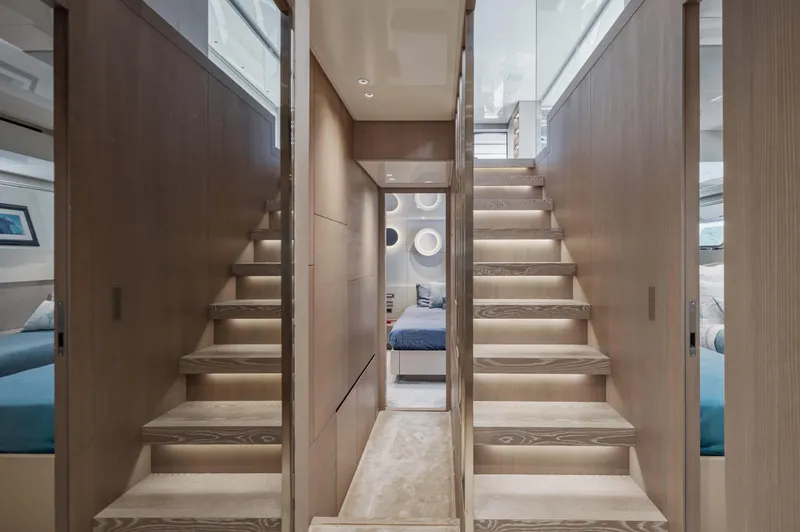 Zafiro III Yacht Photos Pics Luxurious interior of 2020 Sanlorenzo SX88 yacht with elegant wooden stairs and modern design.