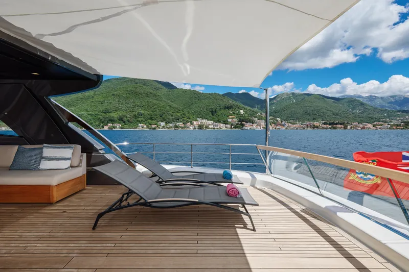 Zafiro III Yacht Photos Pics Luxurious Sanlorenzo SX88 yacht deck with sun loungers, scenic mountain and sea view.