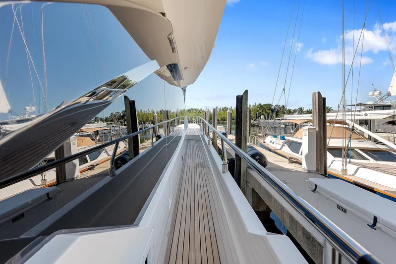 Ascendo Yacht Photos Pics Astondoa 66 yacht deck, 2022 model, docked at marina under clear blue sky.