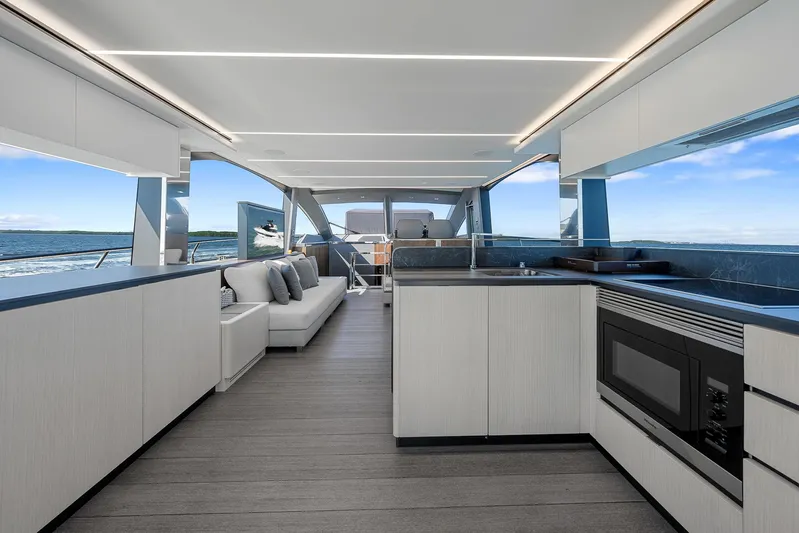 Ascendo Yacht Photos Pics Luxurious interior of 2022 Astondoa 66 yacht with modern kitchen and seating area.