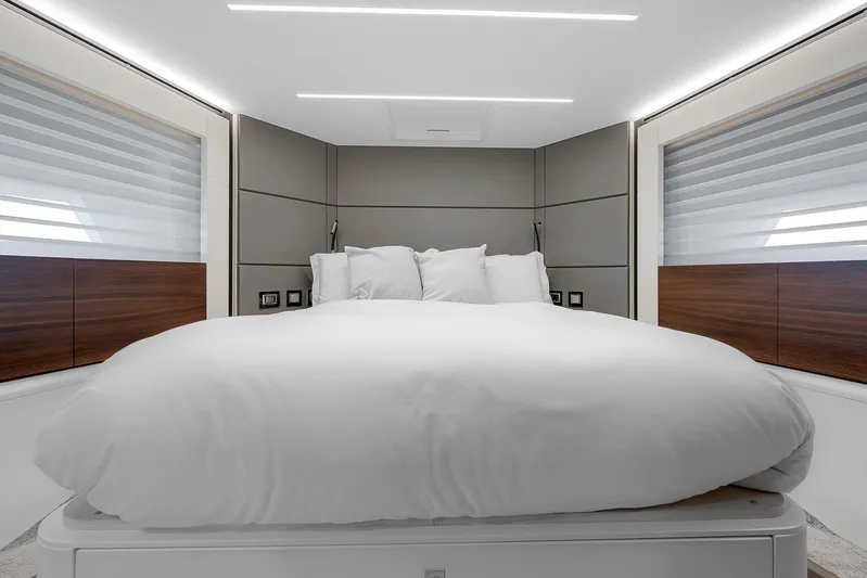 Ascendo Yacht Photos Pics Luxurious bedroom interior of 2022 Astondoa 66 yacht with modern design and cozy bedding.