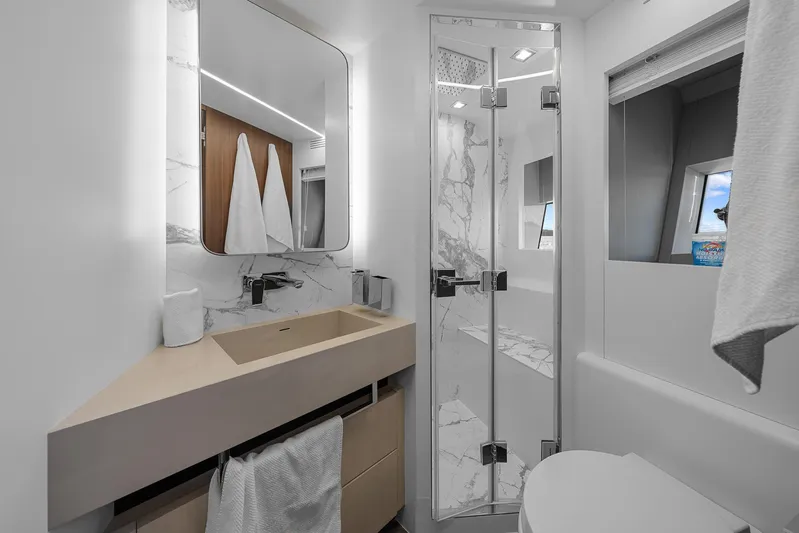 Ascendo Yacht Photos Pics Luxurious bathroom in 2022 Astondoa 66 yacht with modern fixtures and marble accents.