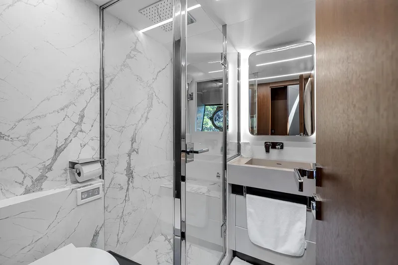 Ascendo Yacht Photos Pics Luxurious bathroom in 2022 Astondoa 66 yacht with marble walls and modern fixtures.