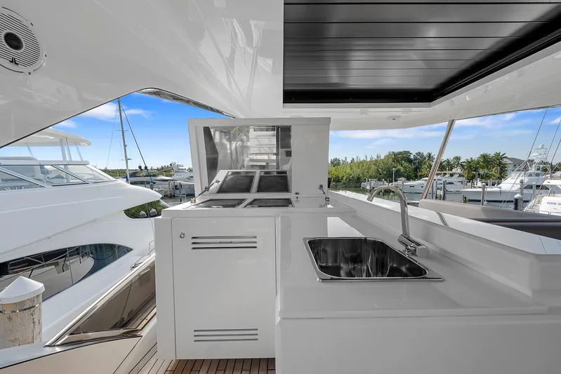 Ascendo Yacht Photos Pics Astondoa 66 yacht 2022, sleek outdoor kitchen with sink and grill, marina view.