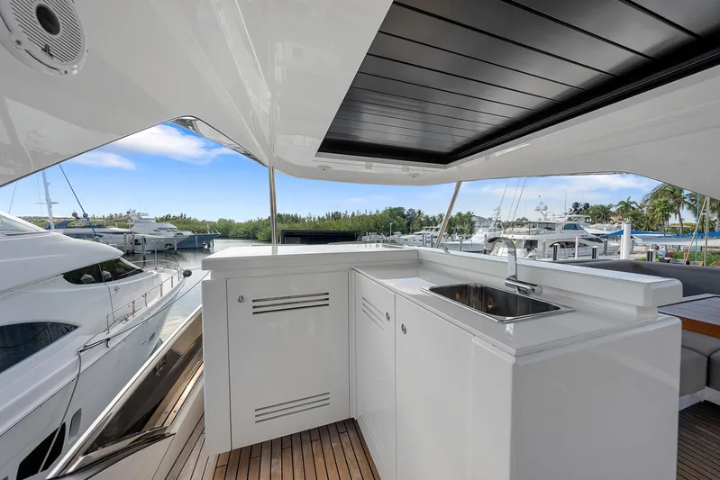 Ascendo Yacht Photos Pics Astondoa 66 yacht 2022, featuring sleek outdoor kitchen and scenic marina view.