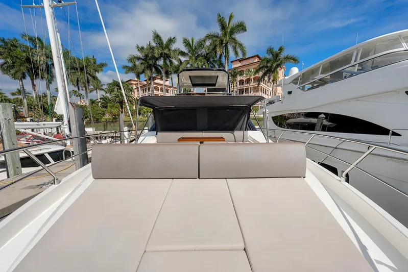 Ascendo Yacht Photos Pics Astondoa 66 yacht 2022, docked with sunbed, palm trees, and luxury marina backdrop.