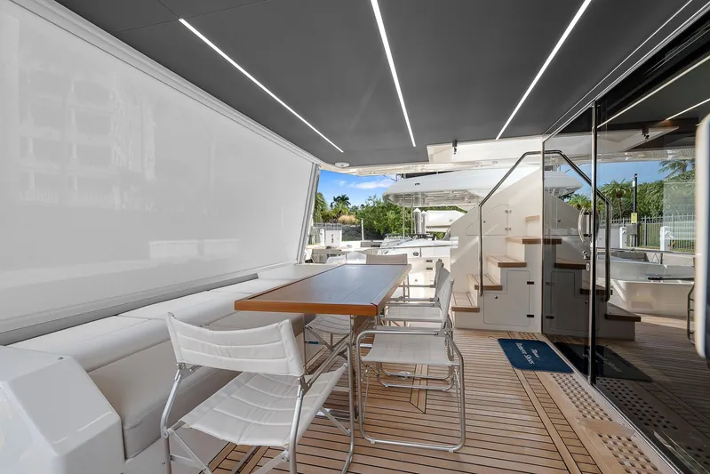 Ascendo Yacht Photos Pics Astondoa 66 yacht 2022, elegant outdoor seating area with modern design and wooden flooring.