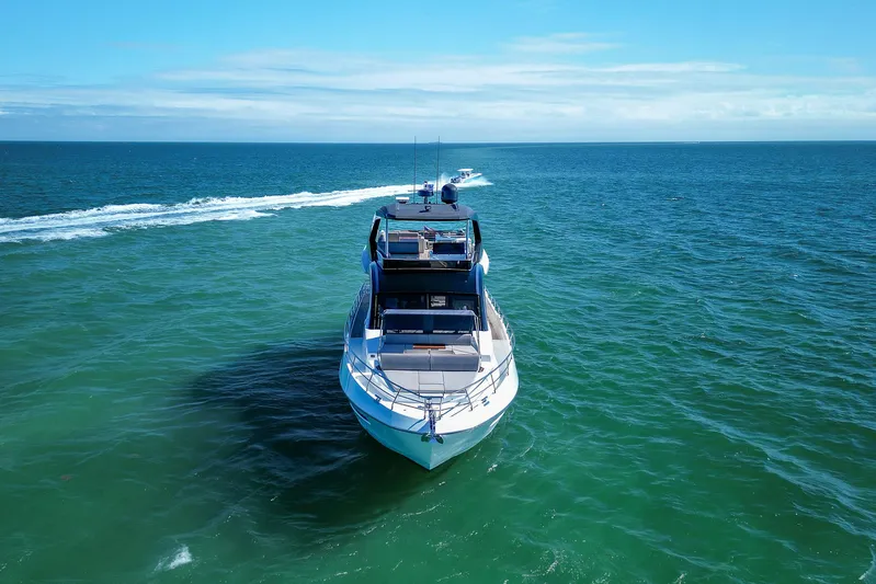 Ascendo Yacht Photos Pics 2022 Astondoa 66 yacht cruising on open sea under clear blue sky.