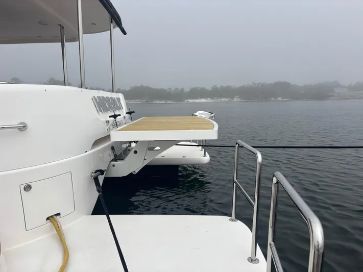 Hideout Yacht Photos Pics 2022 Horizon PC65 yacht with extended platform on a foggy lake.