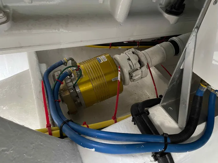 Hideout Yacht Photos Pics Engine room of 2022 Horizon PC65 yacht with visible machinery and cables.