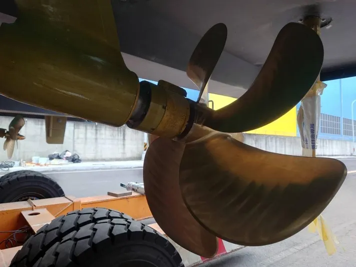 Hideout Yacht Photos Pics Close-up of a 2022 Horizon PC65 boat propeller on a trailer.