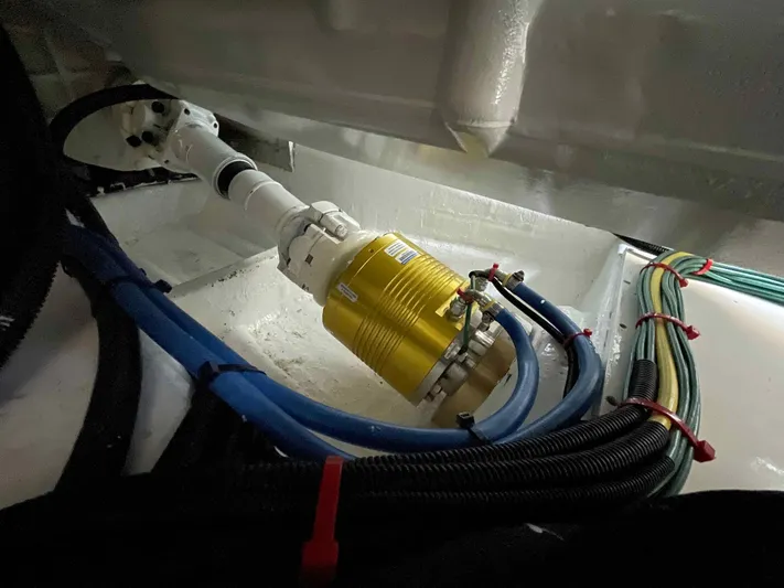 Hideout Yacht Photos Pics Engine compartment of 2022 Horizon PC65 with cables and a yellow component.