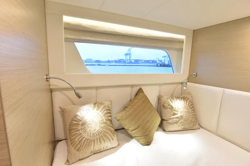 Hideout Yacht Photos Pics Luxurious cabin interior of 2022 Horizon PC65 yacht with elegant pillows and sea view.
