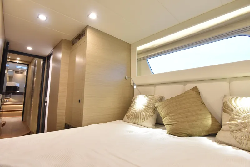 Hideout Yacht Photos Pics Luxurious bedroom interior on 2022 Horizon PC65 yacht, featuring elegant design and ambient lighting.