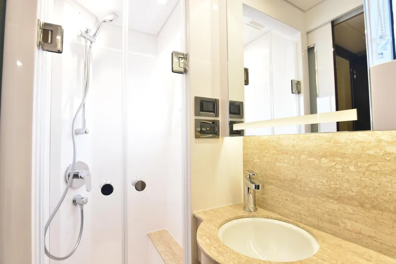 Hideout Yacht Photos Pics Modern bathroom with shower and sink in 2022 Horizon PC65 yacht.